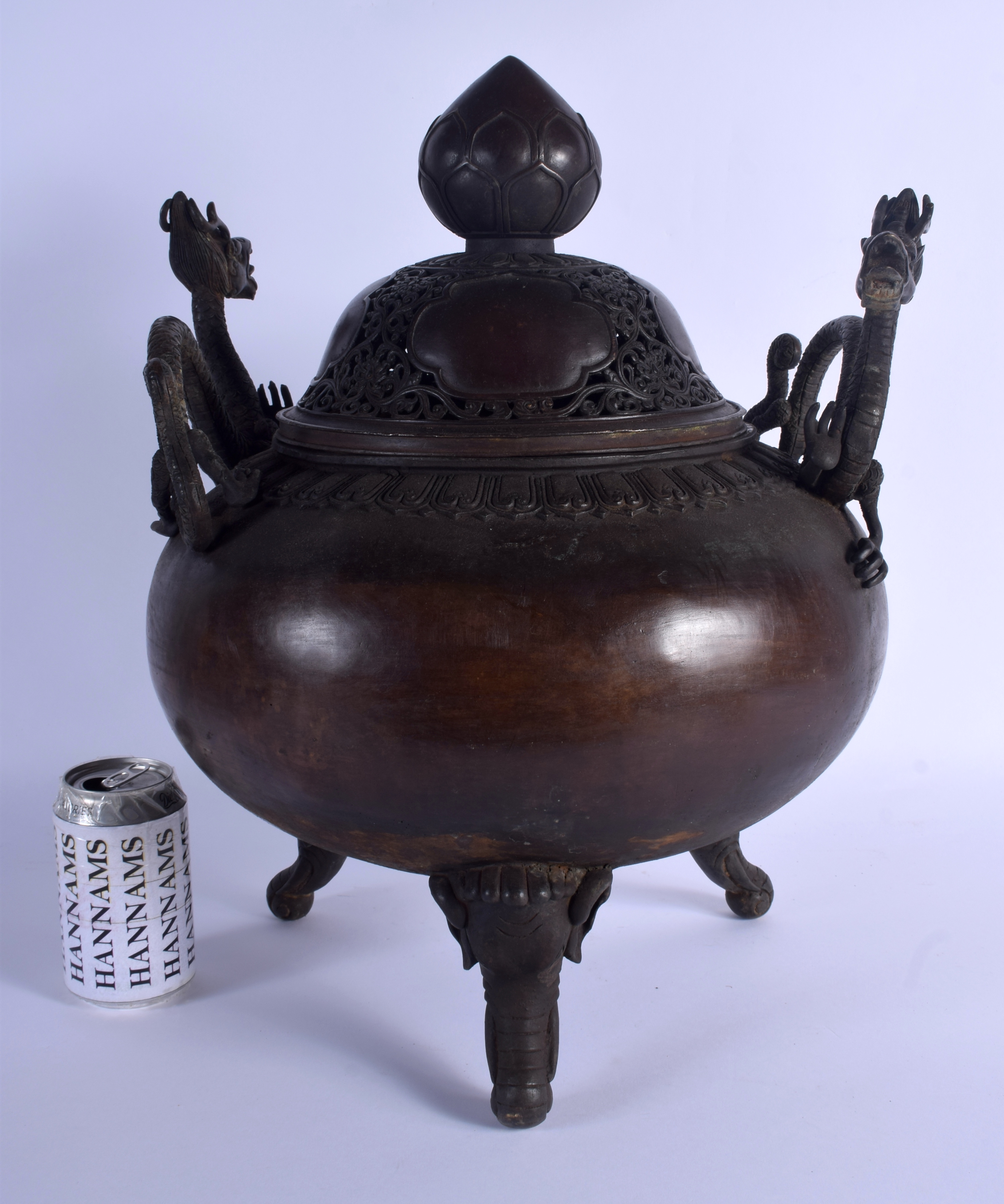 A LARGE CHINESE TWIN HANDLED BRONZE CENSER AND COVER 20th Century, decorated with foliage and vines.