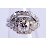 AN ART DECO PLATINUM AND DIAMOND CLUSTER RING. G. Central stone 0.5 cm x 0.5 cm. 7 grams.