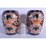 A PAIR OF 19TH CENTURY JAPANESE MEIJI PERIOD IMARI PORCELAIN VASES painted with foliage and insects.