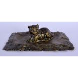 A 19TH CENTURY AUSTRIAN BRONZE FIGURE OF A RECUMBENT CAT by Franz Xavier Bergmann, modelled upon a c