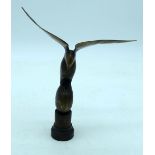 A carved horn bird mounted on a wooden plinth .24cm .