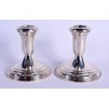 A PAIR OF STERLING SILVER DWARF CANDLESTICKS. 565 grams overall. 9.5 cm high.