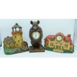 A wooden American art clock of a light house together with a cast iron clock and a bear clock.