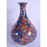 A 19TH CENTURY CHINESE BLUE AND WHITE PORCELAIN VASE Qing, painted with dragons amongst coral colour