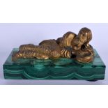 A RARE 19TH CENTURY RUSSIAN GILT BRONZE FIGURE OF A RECLINING MALE modelled upon a malachite base. 1