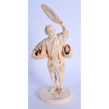 A 19TH CENTURY JAPANESE MEIJI PERIOD CARVED IVORY OKIMONO modelled as a bird catcher holding aloft h