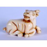 AN EARLY 20TH CENTURY JAPANESE MEIJI PERIOD CARVED IVORY NETSUKE formed as a rearing bullock. 3 cm x