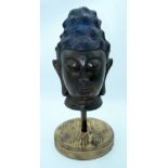 A large bronze Chinese Tibetan head on a stand 37cm