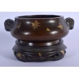 A CHINESE TWIN HANDLED BRONZE CENSER ON STAND 20th Century, decorated with gold splash. 14 cm wide,
