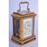 A CONTEMPORARY BRONZE MINIATURE CARRIAGE CLOCK. 10 cm high inc handle.