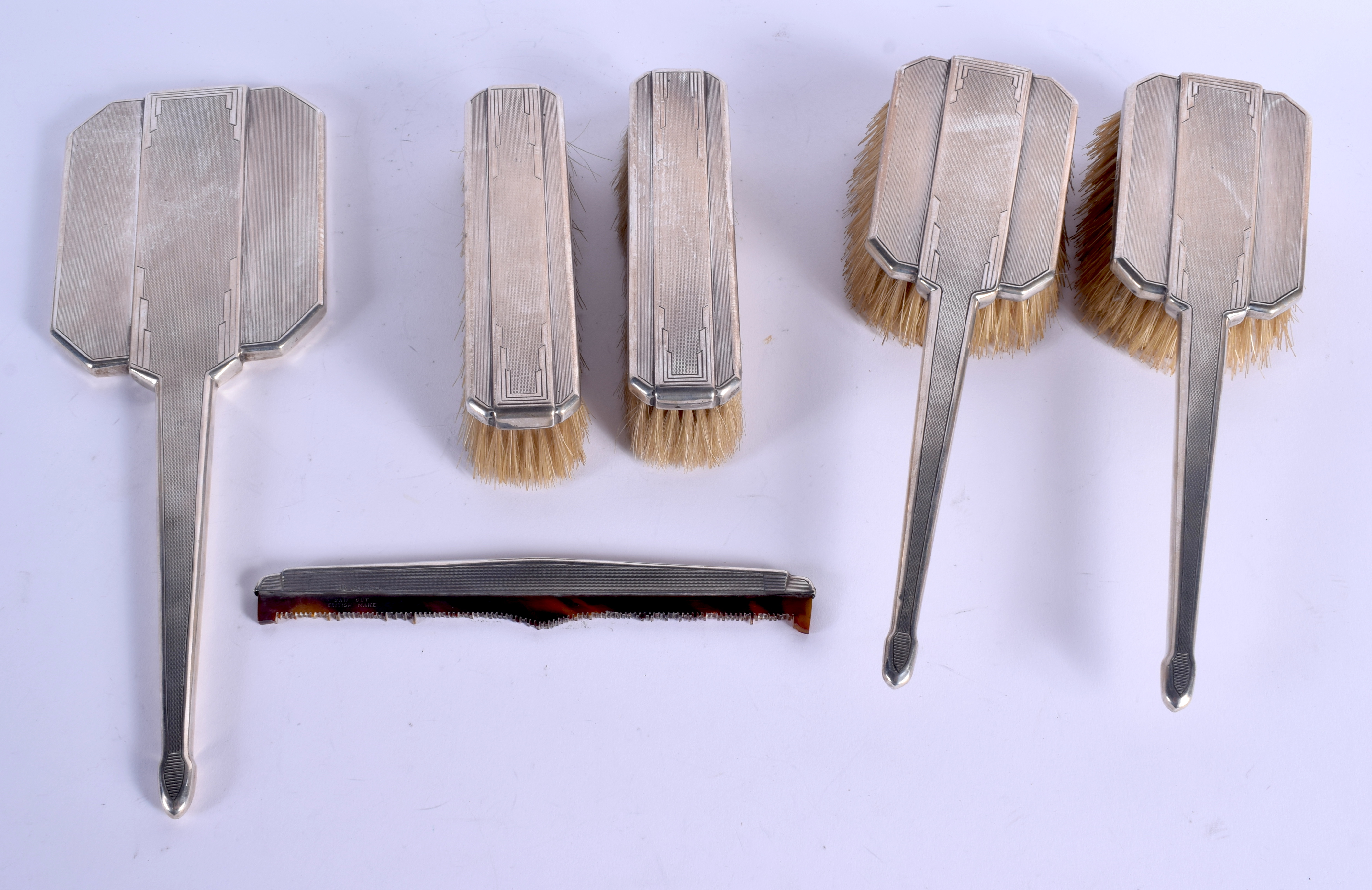 AN ART DECO SILVER DRESSING TABLE SET. Birmingham 1933. 705 grams overall. (6)