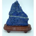 A carved Lapis Lazuli boulder mounted on a stand 19 x 16cm.