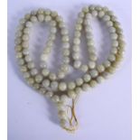 A VERY LONG EARLY 20TH CENTURY CHINESE CARVED JADE NECKLACE Late Qing/Republic. 180 cm long.