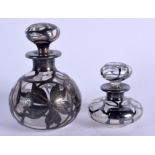 TWO SILVER OVERLAID GLASS SCENT BOTTLES. Largest 11 cm high. (2)