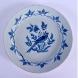 AN 18TH CENTURY EUROPEAN DELFT BLUE AND WHITE PLATE painted with a bird and flowers. 21 cm diameter.