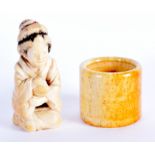A 19TH CENTURY JAPANESE MEIJI PERIOD CARVED IVORY OKIMONO together with a Chinese bone archers ring.