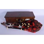 A PAIR OF VINTAGE SCOTTISH IVORY CAPPED BAGPIPES within a fitted wooden box. 50 cm long.