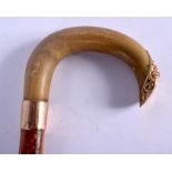 A 19TH CENTURY CONTINENTAL CARVED RHINOCEROS HORN HANDLED WALKING CANE with 18ct gold mounts. 88 cm