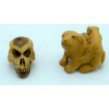 A carved wooden Netsuke inn the form of a dog and a carved wooden skull 4cm (2)