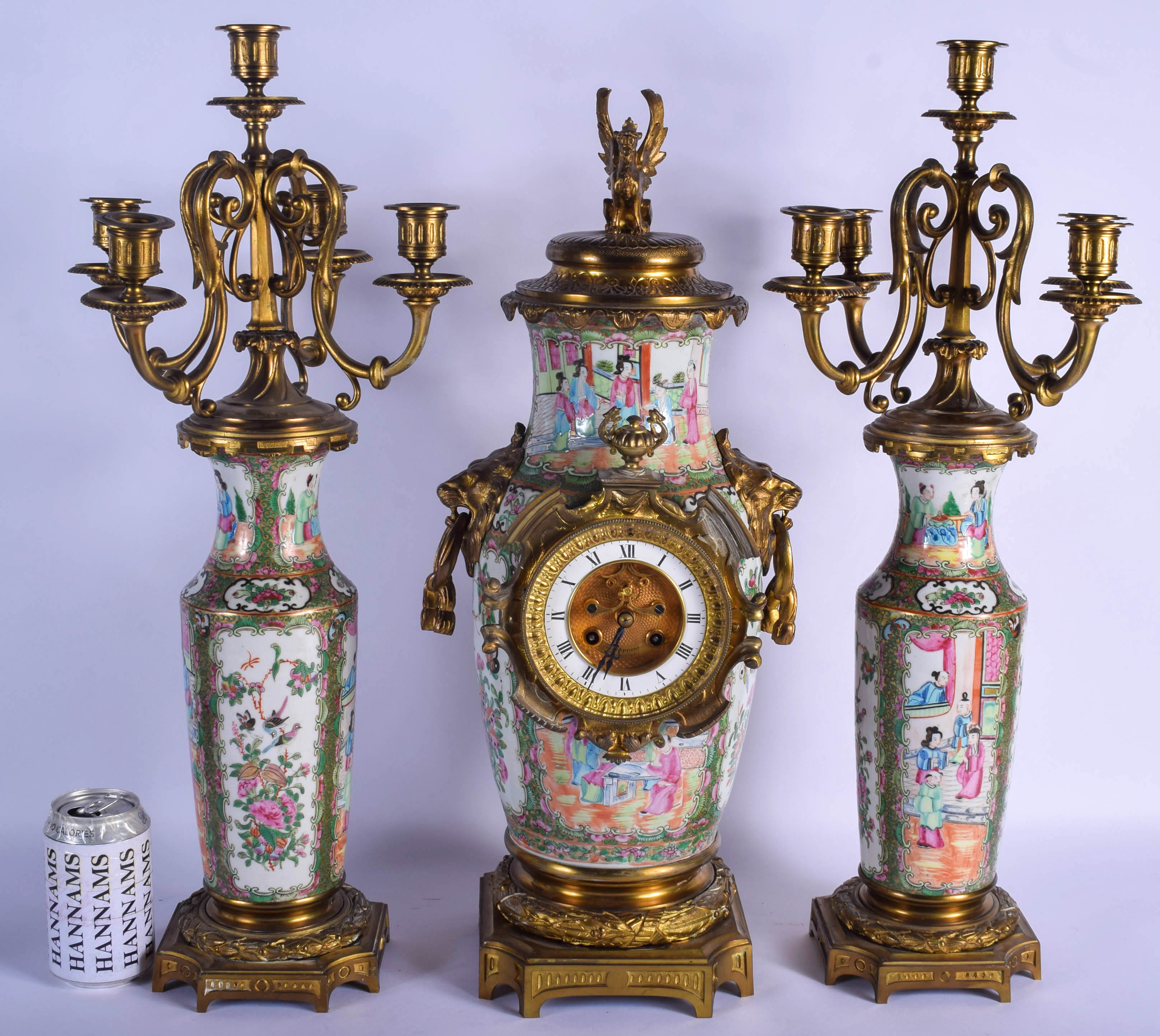 A RARE 19TH CENTURY CHINESE CANTON FAMILLE ROSE CLOCK GARNITURE Qing, painted with figures in variou