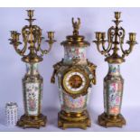 A RARE 19TH CENTURY CHINESE CANTON FAMILLE ROSE CLOCK GARNITURE Qing, painted with figures in variou