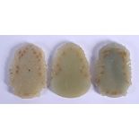 THREE CHINESE CARVED JADE PLAQUE PENDANTS 20th Century, in various forms and sizes. Largest 5 cm x 5