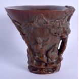 A CHINESE CARVED BUFFALO HORN TYPE LIBATION CUP 20th Century. Decorated with figures and landscapes.