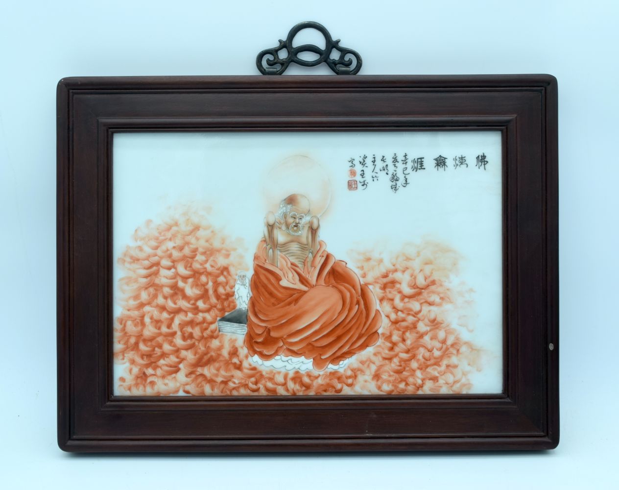 A framed Chinese porcelain panel depicting a figure and calligraphy 35 x 23 cm.