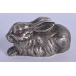 A CONTINENTAL SILVER AND RUBY EYED FIGURE OF A RABBIT. 53 grams. 5.5 cm x 3 cm.