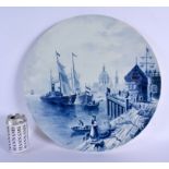 A VERY LARGE CONTINENTAL BLUE AND WHITE POTTERY CHARGER decorated with boating scenes. 45 cm diamete