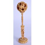 A 19TH CENTURY CHINESE CARVED CANTON BONE PUZZLE BALL ON STAND. 15 cm x 3 cm.