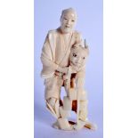 A LATE 19TH CENTURY JAPANESE MEIJI PERIOD CARVED IVORY OKIMONO modelled holding a mask. 11.5 cm high