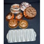 A collection of metal jelly moulds .