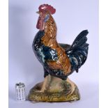 A LARGE 19TH CENTURY CONTINENTAL MAJOLICA FIGURE OF A ROAMING COCK modelled upon a naturalistic base