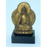 A small Chinese Tibetan gilt bronze Buddha mounted on a base. 7cm.