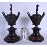 A PAIR OF 19TH CENTURY EUROPEAN GRAND TOUR BRONZES AND COVERS upon red and black marble bases. 34 cm