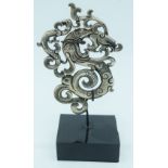 A Chinese white metal dragon plaque on a stand 8cm.