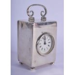 AN EDWARDIAN SILVER MINIATURE CARRIAGE CLOCK with circular dial. 354 grams overall. 8 cm x 5.5 cm.