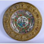 A 19TH CENTURY CHINESE CANTON FAMILLE ROSE PORCELAIN DISH Qing, within a bronze frame. 21.5 cm diame