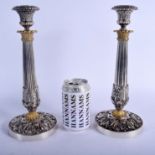 A PAIR OF 19TH CENTURY FRENCH SILVER PLATED CANDLESTICKS overlaid with acanthus capped motifs. 28 cm