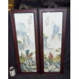 A pair of Hongmu framed Chinese porcelain panels decorated with a Famille verte landscape 82 x 29cm