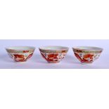 A SET OF THREE EARLY 20TH CENTURY CHINESE FAMILLE ROSE DRAGON TEABOWLS Guangxu mark and period, pain