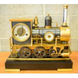 A CONTEMPORARY INDUSTRIAL BRONZE LOCOMOTIVE TRAIN CLOCK upon a set of rails. 44 cm x 46 cm.