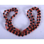 AN ART DECO CORAL AND JET NECKLACE. Each strand 30 cm long.
