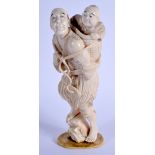 A 19TH CENTURY JAPANESE MEIJI PERIOD CARVED IVORY OKIMONO modelled as a male and child. 19 cm x 5 cm