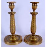A PAIR OF 19TH CENTURY FRENCH EMPIRE STYLE BRONZE CANDLESTICKS. 24 cm high.