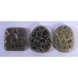 THREE CHINESE CARVED JADE PLAQUE PENDANTS 20th Century, in various forms and sizes. Largest 5 cm x 5