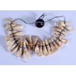 AN EARLY 20TH CENTURY TRIBAL CARVED TOOTH NECKLACE. 21 cm wide.
