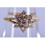 AN 18CT GOLD AND DIAMOND DAISY CLUSTER RING. 3 grams. K.