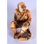 A 19TH CENTURY JAPANESE MEIJI PERIOD CARVED IVORY NETSUKE modelled leaning back. 3 cm x 1 cm.